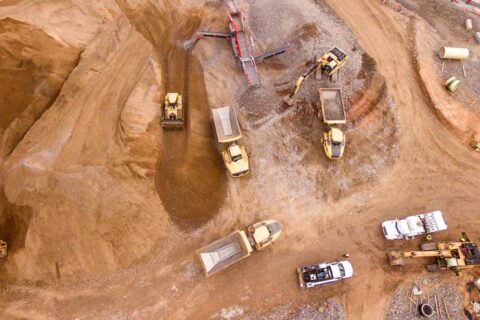 Plusmining, aerial view of mining trucks